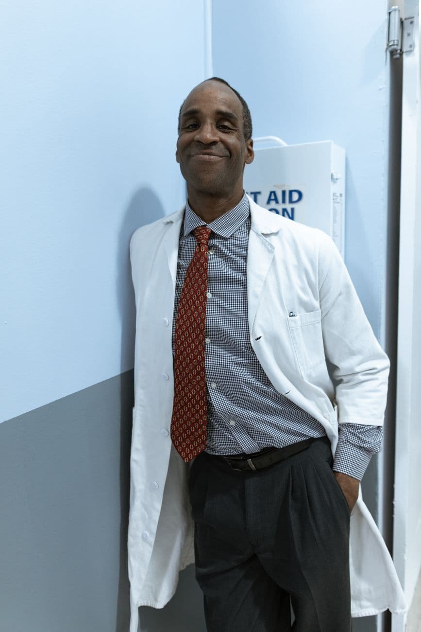 A clinician standing in a hospital corridor