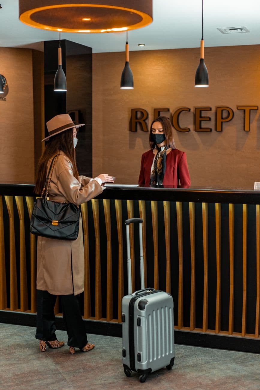 Guests being greeted at a hotel reception desk