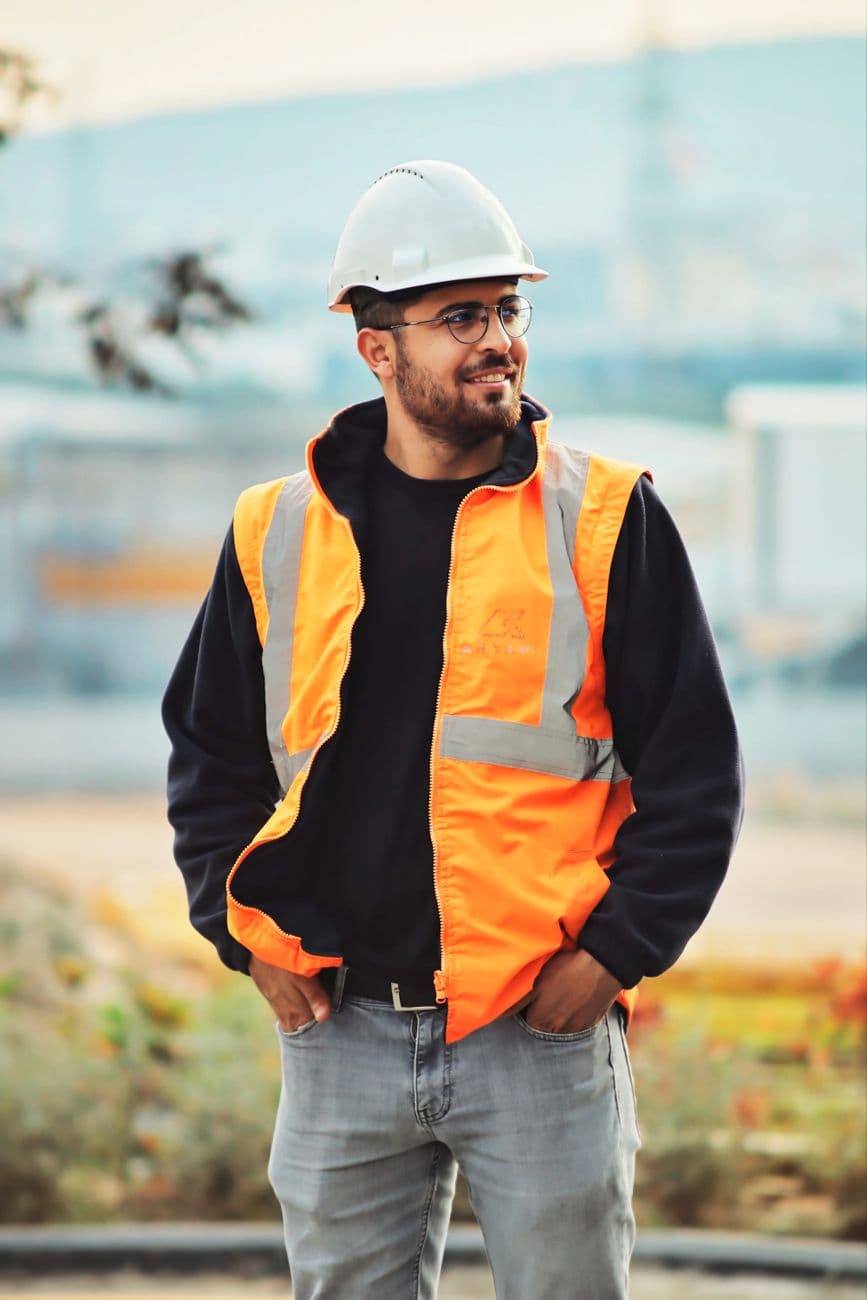 A site worker in a high visibility vest outdoors